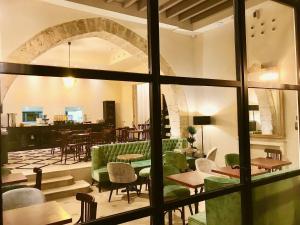 a restaurant with tables and chairs and a large window at Hotel Basilica in Palma de Mallorca