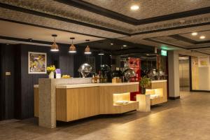 a restaurant lobby with a counter and a bar at Jing Dian Business Hotel in Taoyuan
