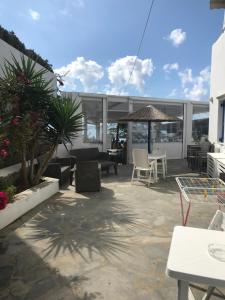 a patio with chairs and tables on a building at Romantika in Platis Gialos