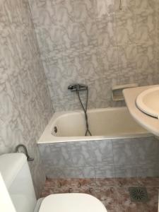 a bathroom with a tub and a toilet and a sink at Romantika in Platis Gialos