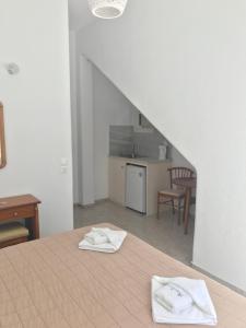 a bedroom with a bed with two white towels on it at Romantika in Platis Gialos