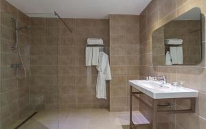 a bathroom with a sink and a shower at Hotel Nour Congress & Resort in Bizerte