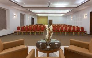 a conference room with chairs and a table with flowers at Hotel Nour Congress & Resort in Bizerte +37 photos