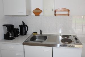 a kitchen with a sink and a coffee maker at Königs Wusterhausen, Grünheide, Senzig in Königs Wusterhausen