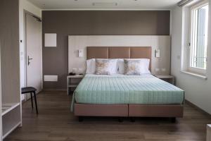 A bed or beds in a room at Albergo Ristorante Belvedere