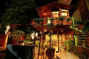 a tree house with a lot of plants at Jaipur Inn in Jaipur