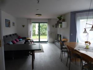 a living room with a couch and a table at Haus Isabella in Boltenhagen