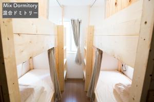 two bunk beds in a room with a window at IZA Enoshima Guest House and Bar in Fujisawa +31 photos