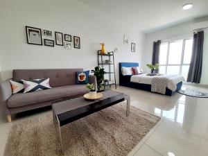 a living room with a couch and a table at Galleria Equine Park @ Seri Kembangan in Seri Kembangan +25 photos