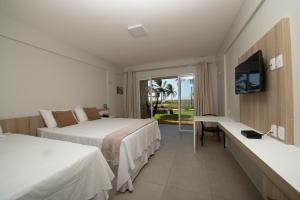 a hotel room with two beds and a television at Locanda dei Venti in Itarema +71 photos