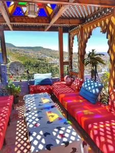 a group of couches sitting on a porch at Dar Lbakal in Chefchaouen