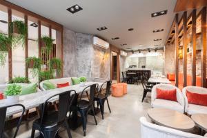 a restaurant with tables and chairs and plants at Sherry Suites Karaköy in Istanbul
