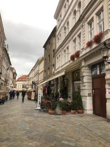 a street with buildings and people walking down a street at JAMES BOND Apartment TOP Location Air Conditioned in Bratislava