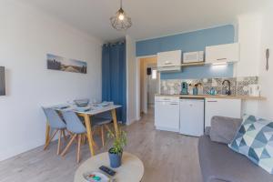 a kitchen and a living room with a table at T2 4pers royan centre proche marché / 10mn plage in Royan