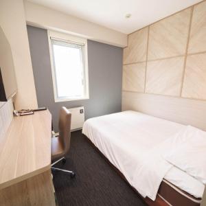 Postel nebo postele na pokoji v ubytování Super Hotel Hida Takayama