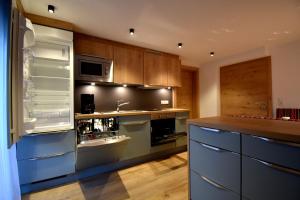 a kitchen with blue cabinets and a counter top at Haus Hubertus in Galtür