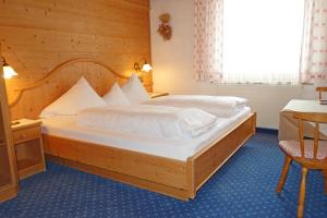 a bedroom with a large wooden bed in a room at Alkira in Sankt Anton am Arlberg