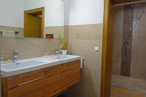 a bathroom with a sink and a shower at Alkira in Sankt Anton am Arlberg