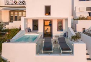 a villa with a swimming pool and a house at Aether Suite by Caldera Houses in Imerovigli