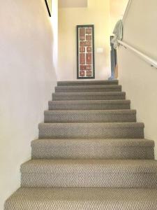 a staircase in a building with a stair case at The big house - 30 days in Kailua-Kona