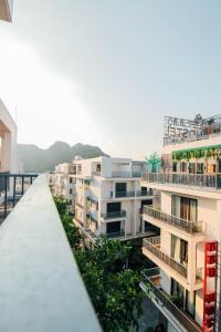 a row of apartment buildings with balconies and trees at Topone Halong Hotel in Ha Long