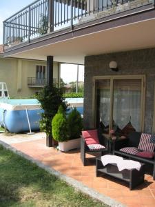 a patio with two couches and a swimming pool at La casa dei pini in Malnate
