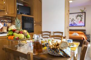 a dining room table with a bowl of fruit on it at A letto nell'Arte in Ascoli Piceno