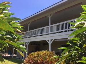 a house with a balcony on the side of it at My Ohana - 30 days in Kailua-Kona