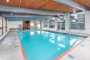 a large swimming pool with blue water in a building at Seashore Inn on the Beach Seaside in Seaside