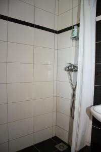 a bathroom with a shower and a sink at Hotel TISA in Busovača