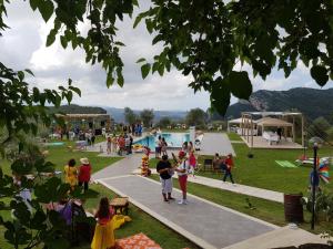 un gruppo di persone in un parco con piscina di L' Aia Resort a Trentinara