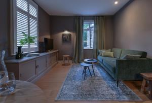 a living room with a couch and a table at Konrads Limburg - Hotel & Gästehaus in Limburg an der Lahn