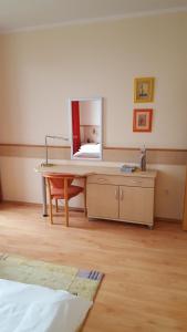 a room with a desk with a mirror on it at AD Šafrán č. 25 in Donovaly