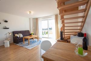 a living room with a staircase and a couch at Haus Dreischläfer deluxe in Dreschvitz