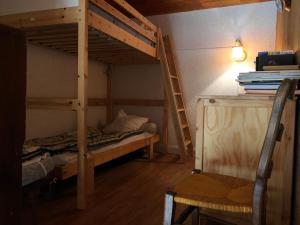 a bedroom with two bunk beds and a chair at Appartement Au Pied Des Pistes in Puy-Saint-Vincent