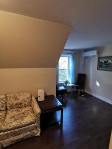 a living room with a couch and a table at By The River B&B in Fredericton