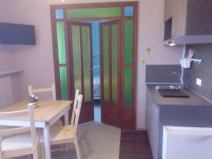 a kitchen with a door and a table and a table and a table at Terre di creta...per sognare in Pomaia