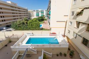 - une vue sur la piscine située entre deux bâtiments dans l'établissement 4 bedroom apartment close by beach in Fuengirola, à Fuengirola