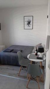 a bedroom with a bed and a table and a table and chairs at Studio Fibra Metrio in Rybnik