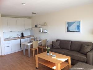 a living room with a couch and a table at Wohnung Tornblick in Borkum