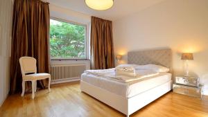 sypialnia z łóżkiem, oknem i krzesłem w obiekcie Vienna Residence, Naschmarkt - Karlsplatz w Wiedniu