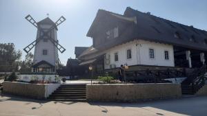 a large building with a windmill in front of it at Диканька на Тамани 2 in Taman
