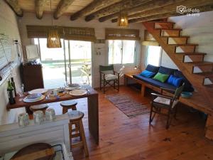 a living room with a staircase in a house at Palapas al mar in Punta Del Diablo