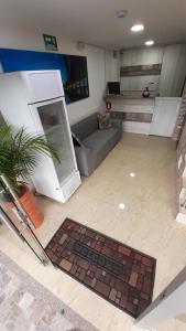 a living room with a couch and a tv at Hotel Boutique Street 50 in Medellín