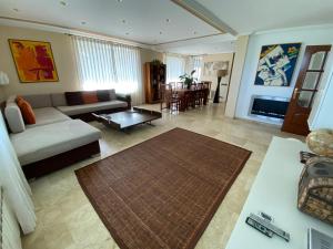 a living room with a couch and a table at VILLA SA CALMA in Zaragoza