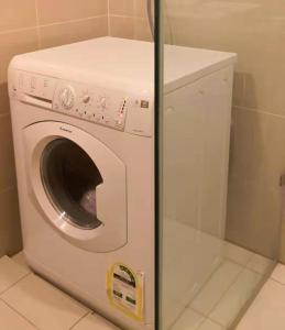 a washer and dryer sitting in a bathroom at ONE UPTOWN RESIDENCE in Manila