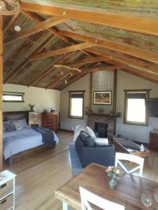 a living room with a bed and a couch at Baroona Cottage in Barwite