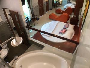 a bathroom with a bed and a sink and a tub at Thanh Thuy in Cu Chi