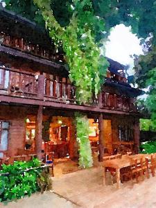 a painting of a building with a table and chairs at Riverhouse Hotel (The Teak House) in Mae Sariang