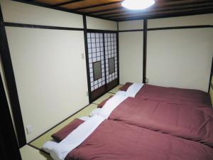 A bed or beds in a room at Utatei Nada